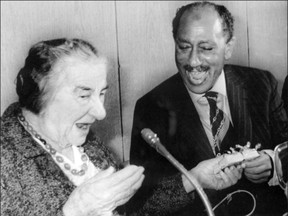 A file picture dated 21 November 1977 shows then Israeli Prime Minister Golda Meir exchanging presents with Egyptian President Anwar Sadat in Jerusalem.