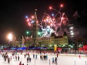 Fireworks explode above Centre Block's Peace Tower as skaters look on from the Canada 150 ice rink during the illumination launch ceremony of Christmas Lights Across Canada on Parliament Hill in Ottawa on Thursday, Dec. 7, 2017.