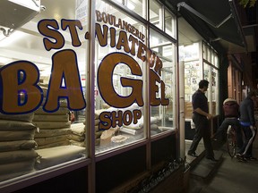 A customer walks out of the St. Viateur bagel shop in Montreal on Monday, October 27, 2014.