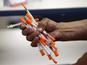 Used needles are shown at a needle exchange in Miami, May 6, 2019. A constitutional challenge to the federal government's refusal to provide clean needles in prisons is set to be heard by an Ontario court this week.