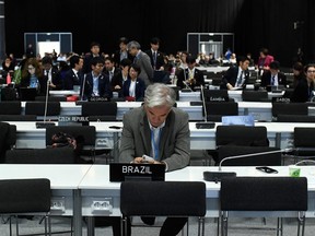 Delegates wait for the start of the closing plenary session of the UN Climate Change Conference COP25 at the 'IFEMA - Feria de Madrid' exhibition centre, in Madrid, on Dec. 15, 2019.