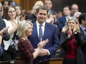 Leader of the Opposition Andrew Scheer is applauded by caucus members as he announces he will step down as leader of the Conservatives, Thursday, December 12, 2019 in the House of Commons in Ottawa.