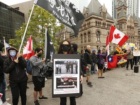 Anti-China demonstrators protest a flag-raising held at Toronto city hall by a pro-Beijing group on Sept. 30, 2019, to mark China's 70th anniversary.