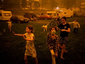 Children play at the showgrounds in the southern New South Wales town of Bega where they are camping after being evacuated from nearby sites affected by bushfires on December 31, 2019