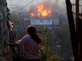 A house burns following the spread of wildfires in Valparaiso, Chile, December 24, 2019.