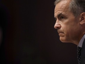 Mark Carney the Governor of the Bank of England listens to a journalist's question during a Financial Stability Report press conference at the Bank of England in the City of London, Thursday, July 11, 2019.