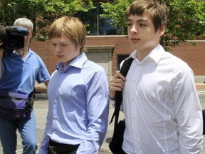 In this July 1, 2010 file photo, Alexander Vavilov, right, and his older brother brother Timothy leave a federal court after a bail hearing for their parents Donald Heathfield and Tracey Ann Foley, in Boston, Massachusetts.