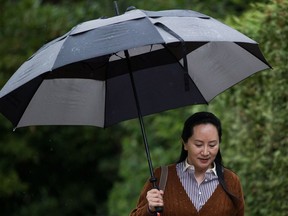 Huawei chief financial officer Meng Wanzhou, who is out on bail and remains under partial house arrest after she was detained last year at the behest of American authorities, carries an umbrella to shield herself from rain as she leaves her home to attend a court hearing, in Vancouver on Thursday October 3, 2019. Wanzhou says she has experienced feelings of helplessness, torment and struggle since being arrested one year ago, but no long fears the unknown.