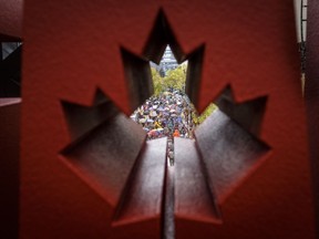 Some of Canada's biggest oil companies are joining forces with environment leaders to find a way through the juggernaut of climate policy and economic development in this country. People march through the downtown core during the climate strike in Calgary, Friday, Sept. 27, 2019.