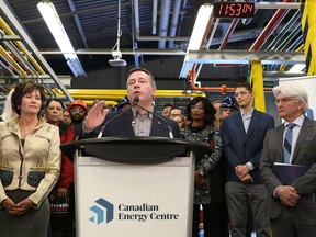 Alberta Premier Jason Kenney, centre, addresses attendees at a press conference to announce the launch of the Canadian Energy Centre at SAIT in Calgary, Alberta Wednesday, December 11, 2019. U.S.-based software giant says it is looking into whether Alberta's new energy war room has violated its trademarked logo.