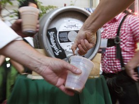 Alberta's top court is dismissing the province's appeal of a ruling that disallowed a program intended to promote sales of local craft beers. People pour beers from a keg of specially brewed beer during the opening day of The Bavarian Festival at Harvey Kern Pavilion in Frankenmuth, Mich., Thursday, June 11, 2015.