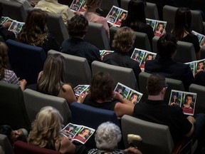 People look at photographs of Carson Crimeni on programs during a celebration of life for the late 14-year-old during a celebration of life for the teenager in Langley, B.C. on Thursday August 29, 2019.