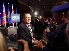 About a year ago, Jason Kenney stood in front of 1,500 raucous supporters in Calgary and called the federal carbon tax an act of "economic masochism" that he would do everything in his power to fight if elected premier. United Conservative Party Leader Jason Kenney greets supporters at an anti-carbon tax rally in Calgary, Friday, Oct. 5, 2018.