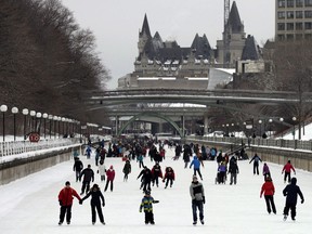 The Chateau Laurier is seen behind skaters on the the Rideau Canal Skateway on the first weekend of the National Capital Commission's Winterlude Festival in Ottawa, Saturday, Jan. 30, 2016.