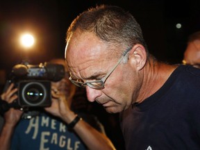 Douglas Garland is escorted into a Calgary police station in connection with the disappearance of Nathan O'Brien and his grandparents in Calgary, Alta., Monday, July 14, 2014. Alberta's top court is expected to release its decision today on the conviction of a man found guilty of killing a couple and their grandson.