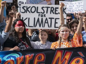 Swedish activist and student Greta Thunberg, centre, takes part in the Climate Strike, in Montreal on Friday, Sept. 27, 2019.