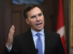 Minister of Finance Bill Morneau makes an announcement on lowering taxes for the middle class in the Foyer of the House of Commons on Parliament Hill in Ottawa on December 9, 2019. Federal Finance Minister Bill Morneau will provide his first update for Canadians today on the state of the economy -- and the government's books -- since the October election. The update comes as Morneau prepares to host provincial finance ministers for two days of talks this week, in which the amount of federal assistance provided to provinces dealing with economic downturns is expected to figure prominently.