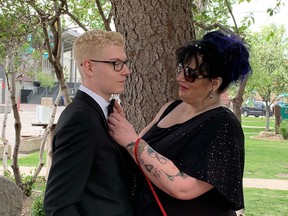 Dawn Warden fixes her son Kyle's tie before his June 2019 high school graduation. The Airdrie, Alta., woman was the victim of a horrific sword attack on June 9, 2019. Thirty-nine-year-old Collin Dennis Ayorech has pleaded guilty in the case.