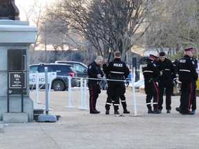 Police stand outside of the Alberta Legislature after being called to the building mid-afternoon for a weapons complaint related to a body that was found on the front steps of building on Monday, December 2, 2019. Edmonton police say they were called to the building mid-afternoon and that what happened was "non-criminal."