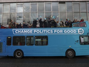 Supporters of the Brexit Party stand on the top deck of an open-topped bus following an announcement of the party's general election polices in London, U.K., on Friday, Nov. 22, 2019. Farage called for an Australian-style points-based immigration system, and said any labor shortages -- including in the state-run National Health Service -- should be managed with temporary work permits.
