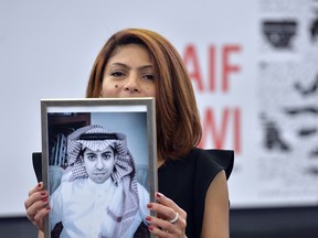 Ensaf Haidar holds a photo of her husband Raif Badawi, after accepting the European Parliament's Sakharov human rights prize on behalf of her husband, who remains imprisoned in Saudi Arabia, on Dec. 16, 2015.
