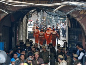 Members of India's National Disaster Response Force (NDRF) head towards the site of a fire that swept through a factory where laborers were sleeping, in New Delhi, India December 8, 2019.