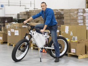 GCSurplus director general Nicholas Trudel poses on an electric bicycle at a GCSurplus warehouse in Montreal, Tuesday, December 3, 2019.