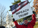 People rally in support of the impeachment of U.S. President Donald Trump in front of the U.S. Capitol on December 18, 2019 in Washington.