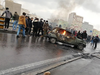 Iranian protesters gather around a burning car during a demonstration against an increase in gasoline prices in the capital Tehran, on Nov. 16, 2019.
