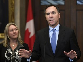Minister of Finance Bill Morneau and Minister of Middle Class Prosperity and Associate Minister of Finance Mona Fortier make an announcement on lowering taxes for the middle class in the Foyer of the House of Commons on Parliament Hill in Ottawa, on Dec. 9, 2019.
