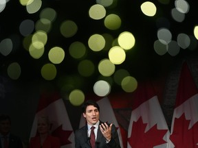 Christmas lights on a wreath glow above Prime Minister Justin Trudeau as he speaks to supporters at the Laurier Club Holiday Reception, an annual donor event held by the Liberal Party of Canada, in Ottawa, Monday, Dec. 9, 2019.