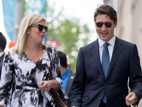 Communications Director Kate Purchase walks with Prime Minister Justin Trudeau to a press conference on June 27, 2017.