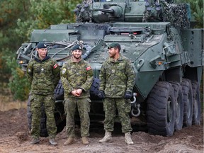 Canadian Army soldiers stand next to their LAV 6 armored personnel carrier during NATO enhanced Forward Presence battle group military exercise Silver Arrow in Adazi, Latvia October 5, 2019. REUTERS