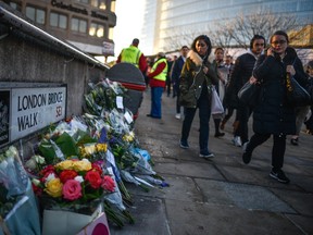 Floral tributes are left for Jack Merritt and Saskia Jones, who were killed in a terror attack, on December 2, 2019 in London, England. Usman Khan, a 28 year old former prisoner convicted of terrorism offences, killed two people in Fishmongers' Hall at the North end of London Bridge on Friday, November 29, before continuing his attack on the bridge.