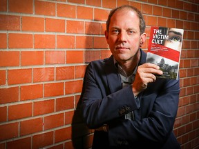 Public policy analyst and author Mark Milke poses with his new book, The Victim Cult: How the Culture of Blame Hurts Everyone and Wrecks Civilizations