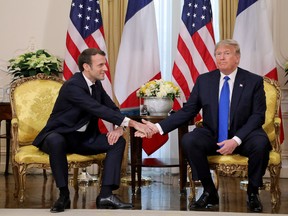 U.S. President Donald Trump shakes hands with France's President Emmanuel Macron, ahead of the NATO summit in Watford, in London, Britain, December 3, 2019.