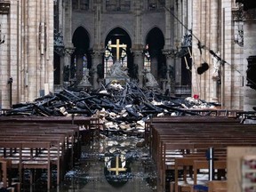 allen debris from the burnt out roof structure sits near the altar inside Notre Dame Cathedral in Paris, France, on Tuesday, April 16, 2019.