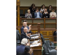 Mike Downie, centre left, and Patrick Downie, centre, right, give the thumbs up after NDP MPP for Windsor-Tecumseh, Percy Hatfield, debates his private memberÕs bill to create a Poet Laureate of Ontario, and establish the role in memory of Gord Downie, late frontman of The Tragically Hip, at Queen's Park in Toronto, Thursday, Dec. 12, 2019.