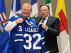 Ontario Premier Doug Ford presents a Toronto Maple Leafs hockey jersey to Quebec Premier Francois Legault as Canada’s provincial premiers meet in Toronto, Dec. 2, 2019.