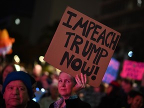 People demonstrate in support of the impeachment of U.S. President Donald Trump, on the eve of the expected House of Representative impeachment vote, December 17, 2019 in downtown Los Angeles, California.