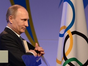 In this file photo taken on February 06, 2014 Russian President Vladimir Putin leaves the stage after delivering his speech at the International Olympic Committee (IOC) Gala Dinner in Sochi, on the eve of the Sochi 2014 Olympic Winter Games opening ceremony. - Russia will miss next year's Tokyo Olympics and the 2022 Beijing Winter Games after the World Anti-Doping Agency on Monday banned the powerhouse from global sporting events for four years over manipulated doping data.