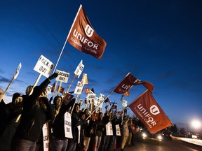 Members of Unifor Local 594 hold signs during a rally outside the Co-op Refinery in Regina on Thursday December 5, 2019.
