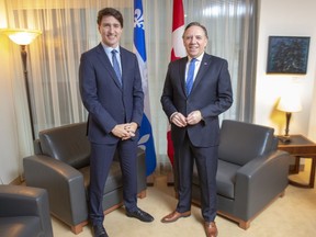 Prime Minister Justin Trudeau and Quebec Premier Francois Legault pose for photos before their first meeting since the election, in Montreal, Friday, Dec. 13, 2019.