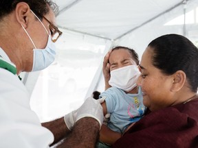 This handout picture taken on December 4, 2019 and released on December 5 by UNICEF Samoa shows one-year-old Sanele receiving her MMR vaccination at the Poutasi district hospital in the Samoan town of Poutasi.