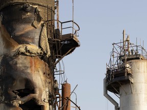 A damaged refining tower stands during repair at Saudi Aramco's Abqaiq crude oil processing plant following a drone attack in Abqaiq, Saudi Arabia