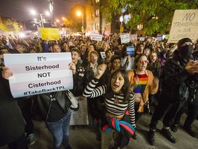 Supporters of the trans community protest outside the Palmerston Public Library in Toronto following a talk by controversial speaker Meghan Murphy on Oct. 29, 2019.