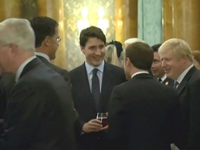 Prime Minister Justin Trudeau appears to laugh with fellow world leaders at Buckingham palace.