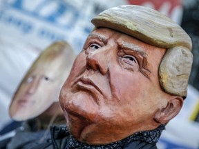Protesters wear masks depicting US President Donald Trump and U.K. Prime Minister Boris Johnson outside of 10 Downing Street in London, U.K., on Monday, Dec. 9, 2019.