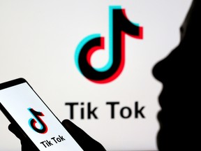 A person holds a smartphone with TikTok logo displayed in this picture illustration taken November 7, 2019.