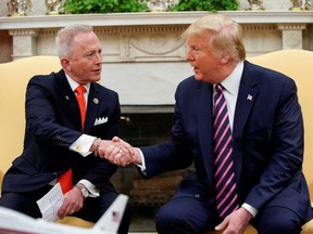 U.S. President Donald Trump shakes hands with U.S. Representative Jeff Van Drew, a Democratic lawmaker who opposed his party's move to impeach Trump, after Van Drew announced he was becoming a Republican  in the Oval Office of the White House in Washington, U.S., December 19, 2019.